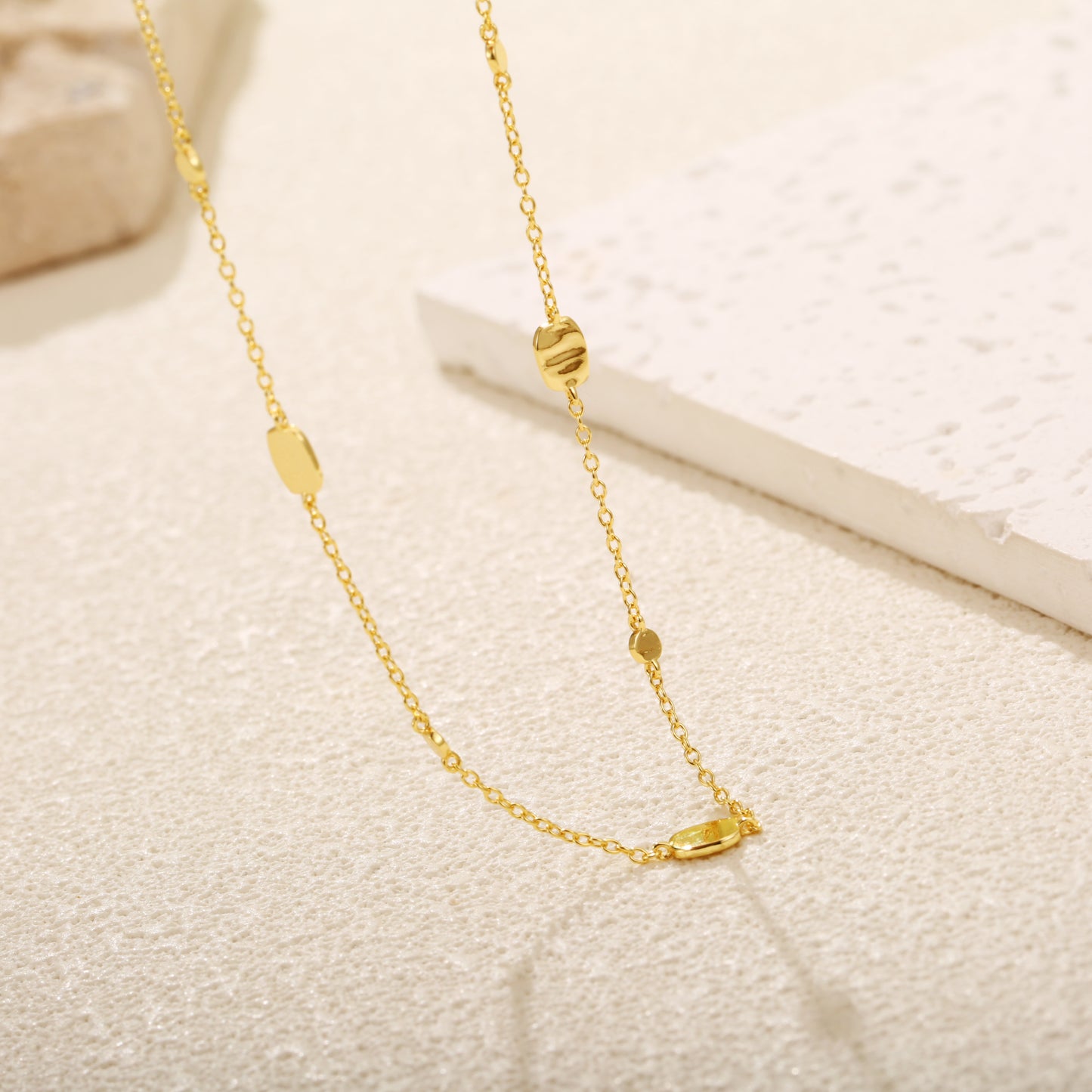 Elegant gold vermeil necklace with small, evenly spaced disc charms.