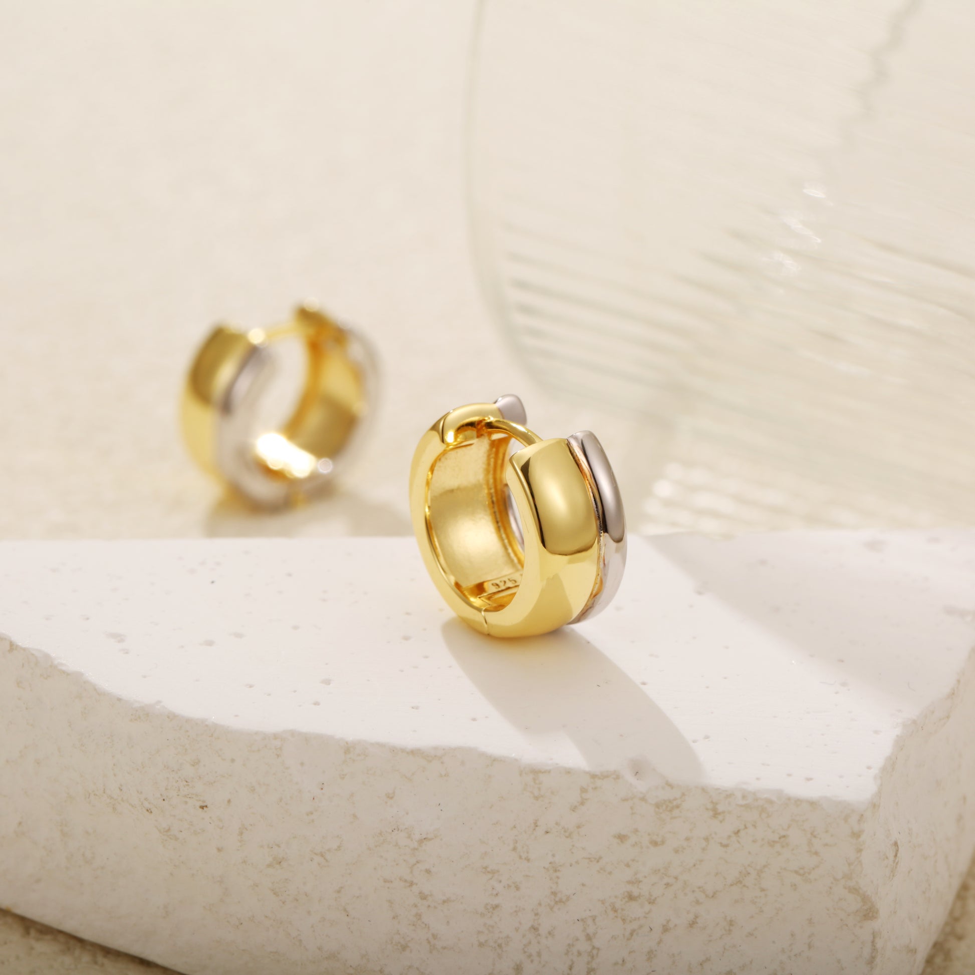 Two-tone gold vermeil huggie earrings with a bold, chunky design