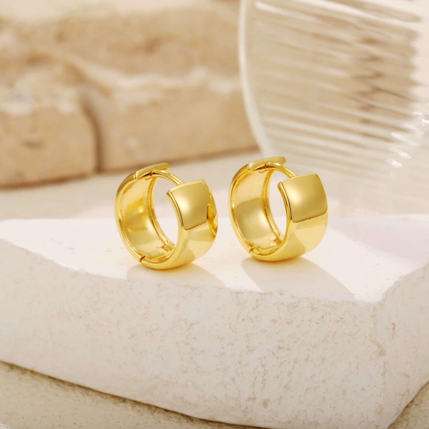 Elegant gold vermeil huggie earrings with a chunky, wide-band design