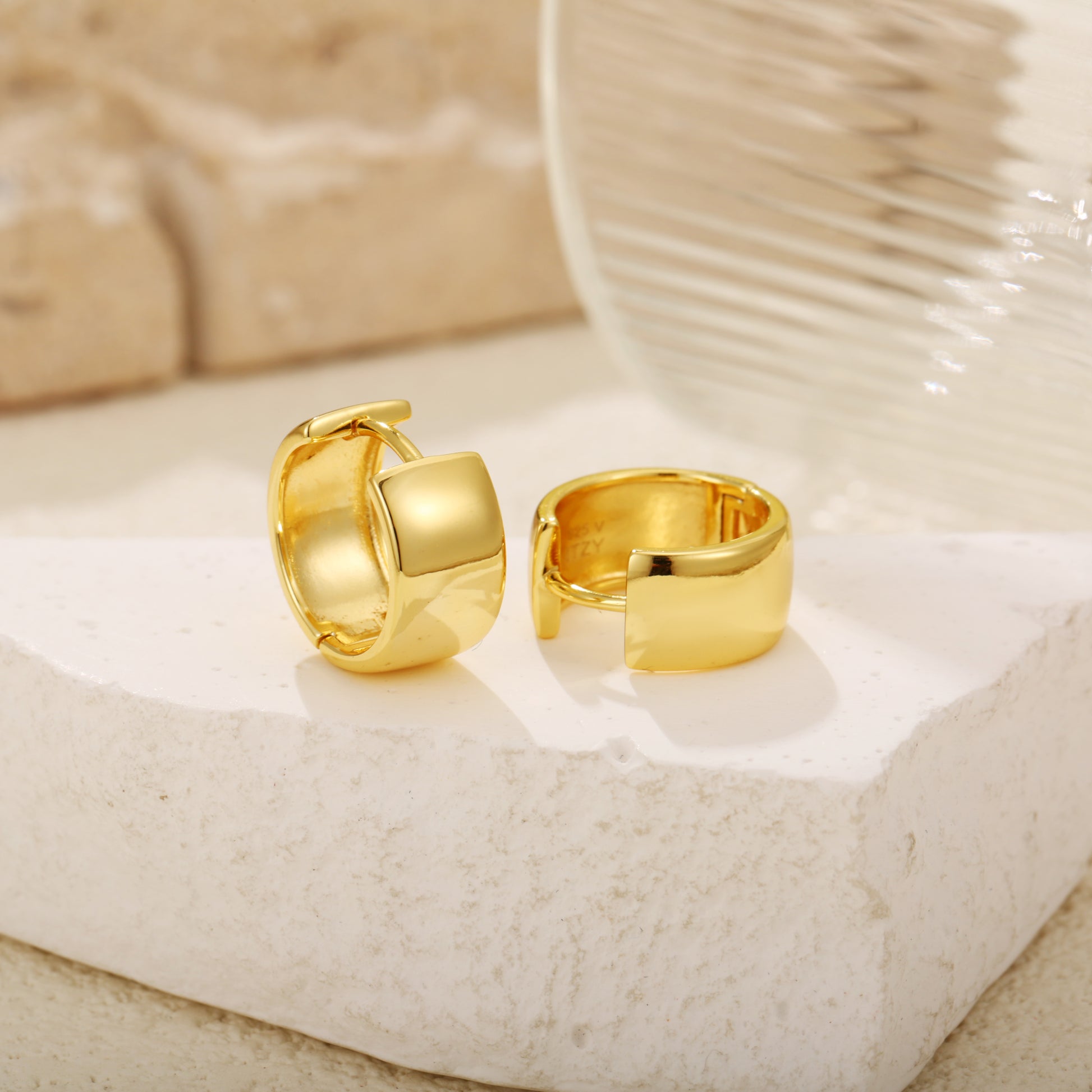 Elegant gold vermeil huggie earrings with a chunky, wide-band design