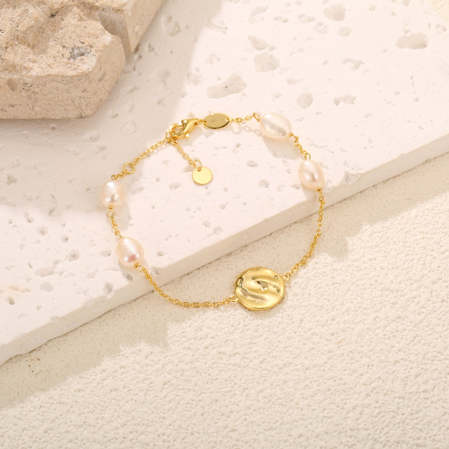 Gold vermeil chain bracelet adorned with evenly spaced, lustrous freshwater pearls, showcasing elegance and versatility in design.