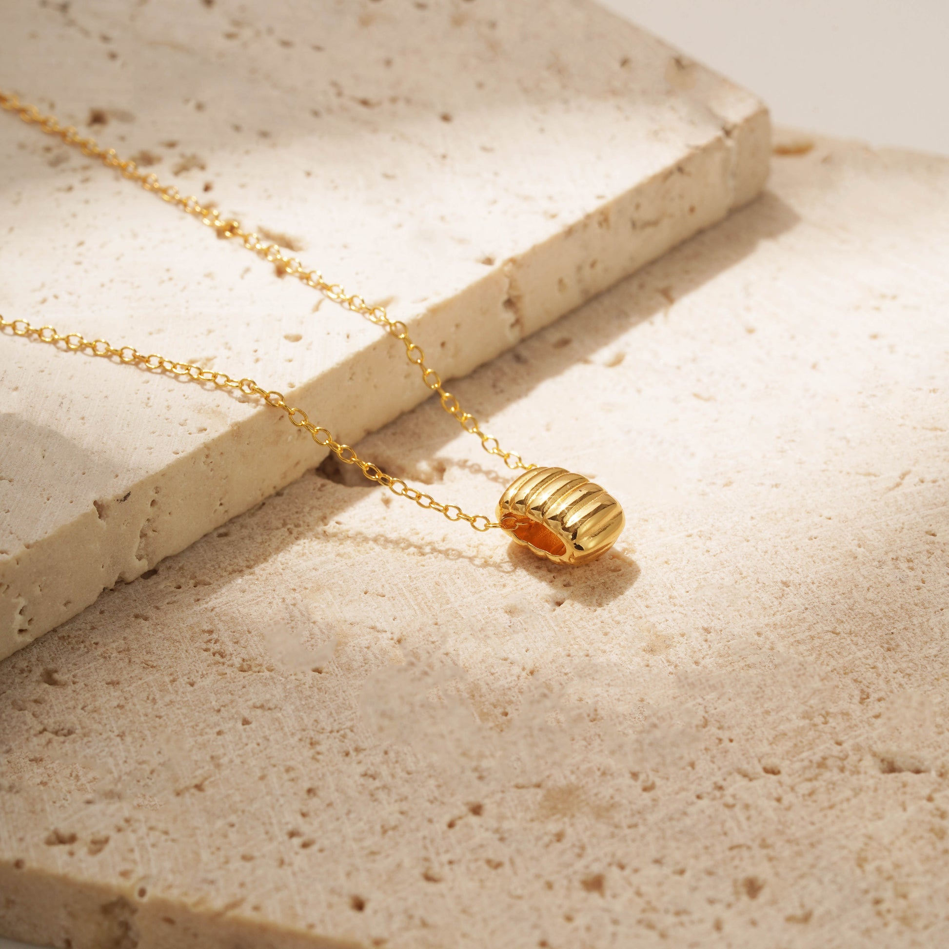 Gold vermeil necklace with a ribbed pendant on a delicate chain